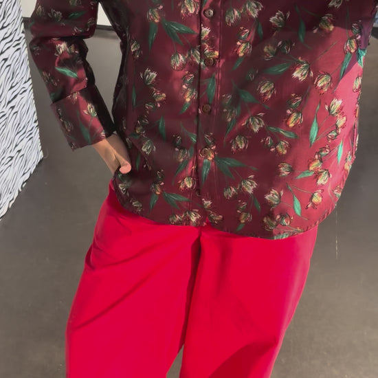 The STEF SERIES Coby long-sleeve shirt in a red floral print combined with the Caro Pants in red velvet from the Autumn Winter 2026 Collection.