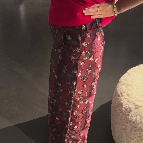 Model wearing the STEF SERIES Caro wide-leg pants in a red floral print from the Autumn Winter 2026 Collection. 