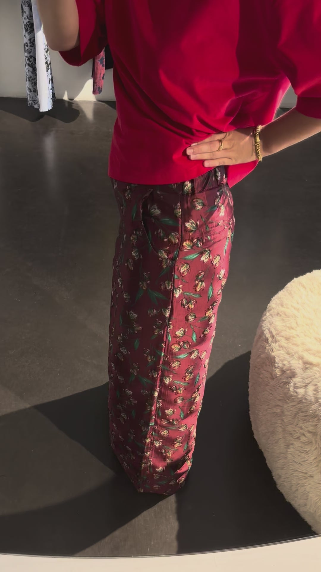 Model wearing the STEF SERIES Caro wide-leg pants in a red floral print from the Autumn Winter 2026 Collection. 