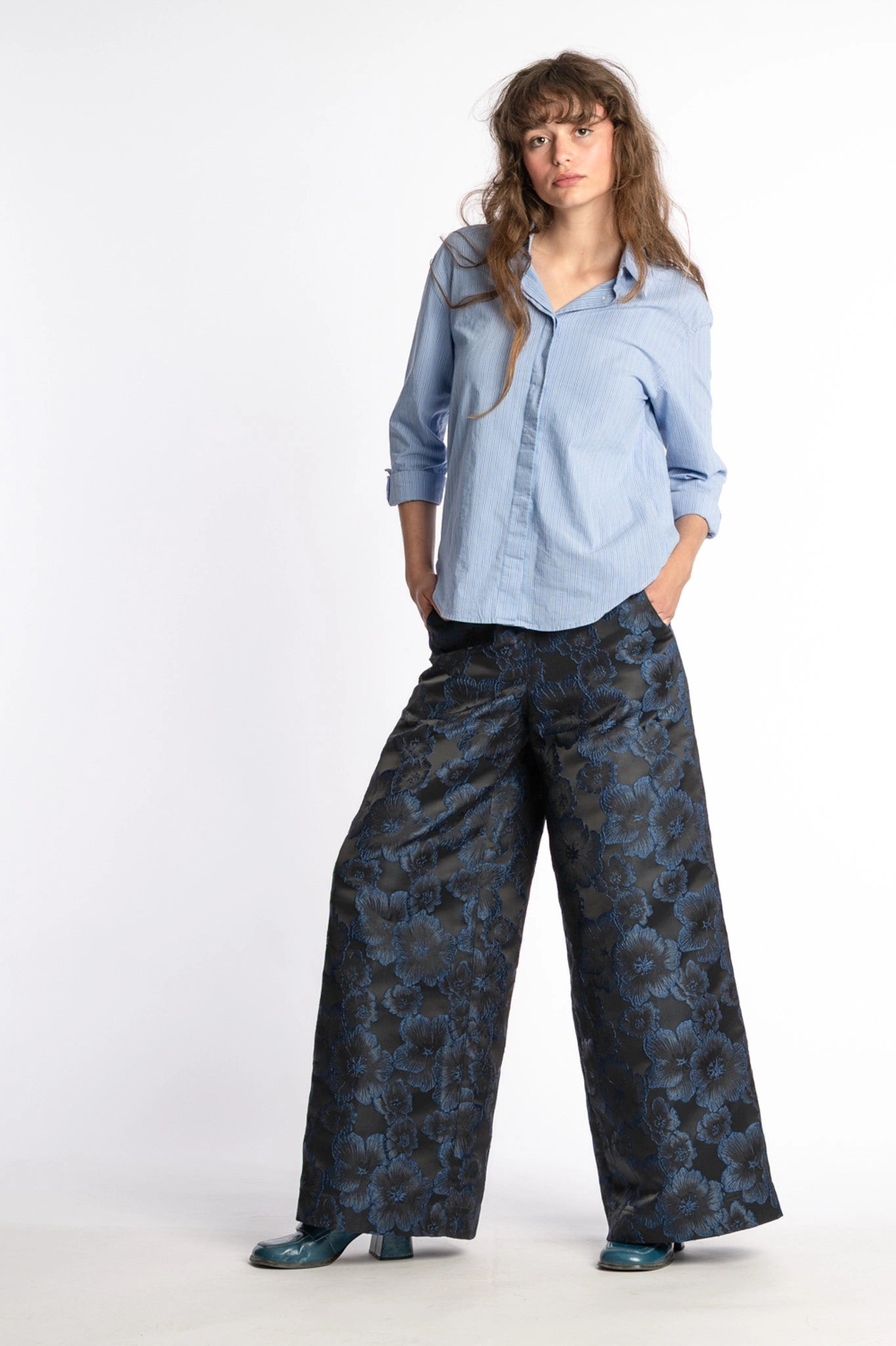 Floral trousers women Ash in black and blue from STEF SERIES AW25, front shown from side.