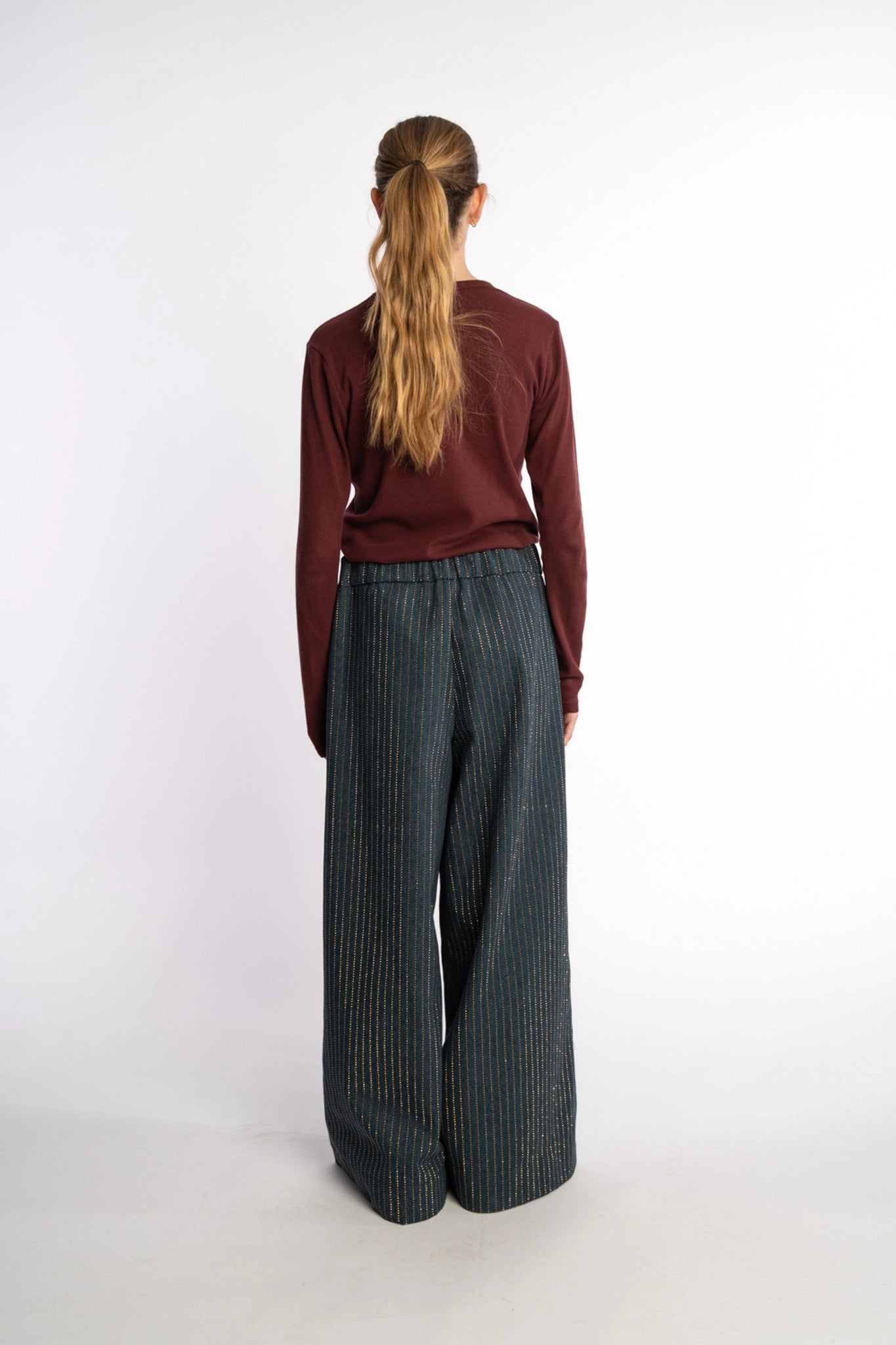 Dark denim pants Ash with gold studs from the STEF SERIES Autumn Winter Collection 2025, shown from back.