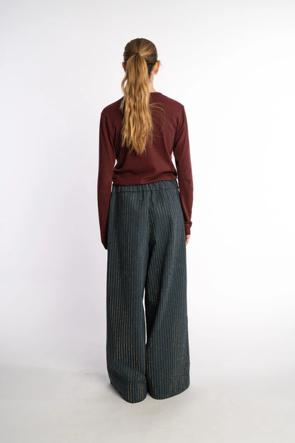 Dark denim pants Ash with gold studs from the STEF SERIES Autumn Winter Collection 2025, shown from back.