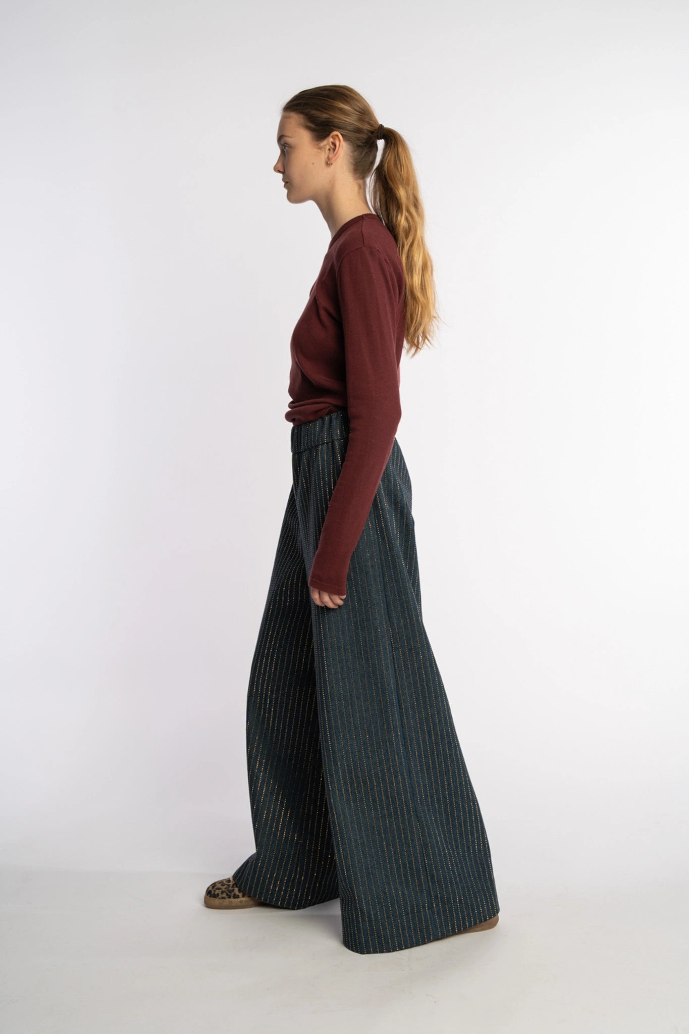 Dark denim pants Ash with gold studs from the STEF SERIES Autumn Winter Collection 2025, shown from left side.