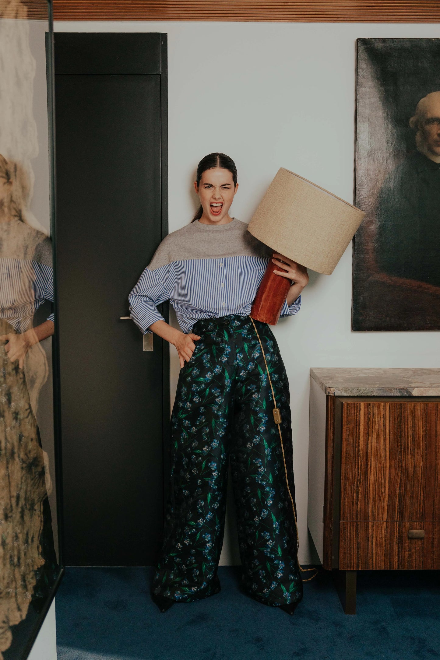 Model wearing the STEF SERIES Caro wide-leg pants in a blue floral print in combination with a blue-striped STEF SERIES Collin poplin shirt.