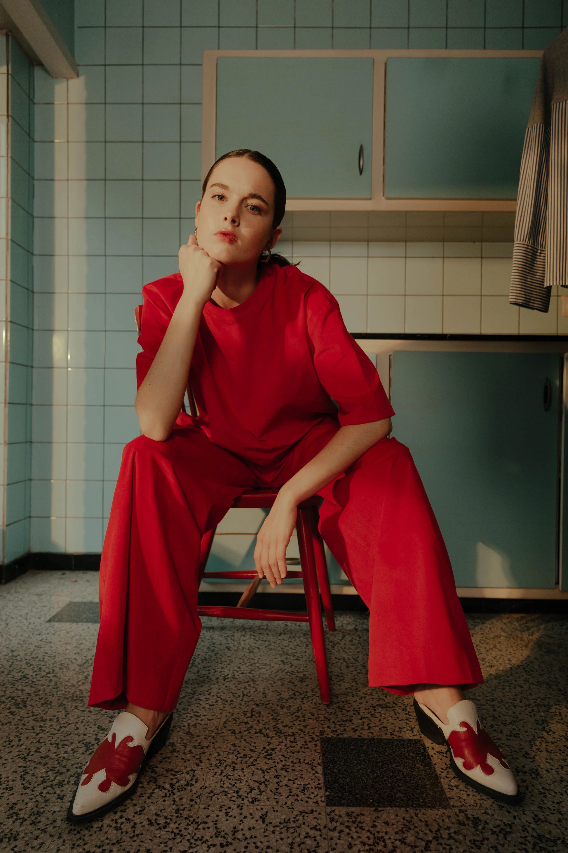 Model wearing the STEF SERIES Caro wide-leg pants in red velvet from the Autumn Winter 2026 Collection.
