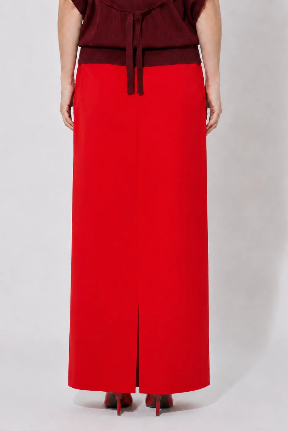 Close-up shot of the back of the STEF SERIES Cas maxi skirt in red velvet from the Autumn Winter 2026 Collection. 