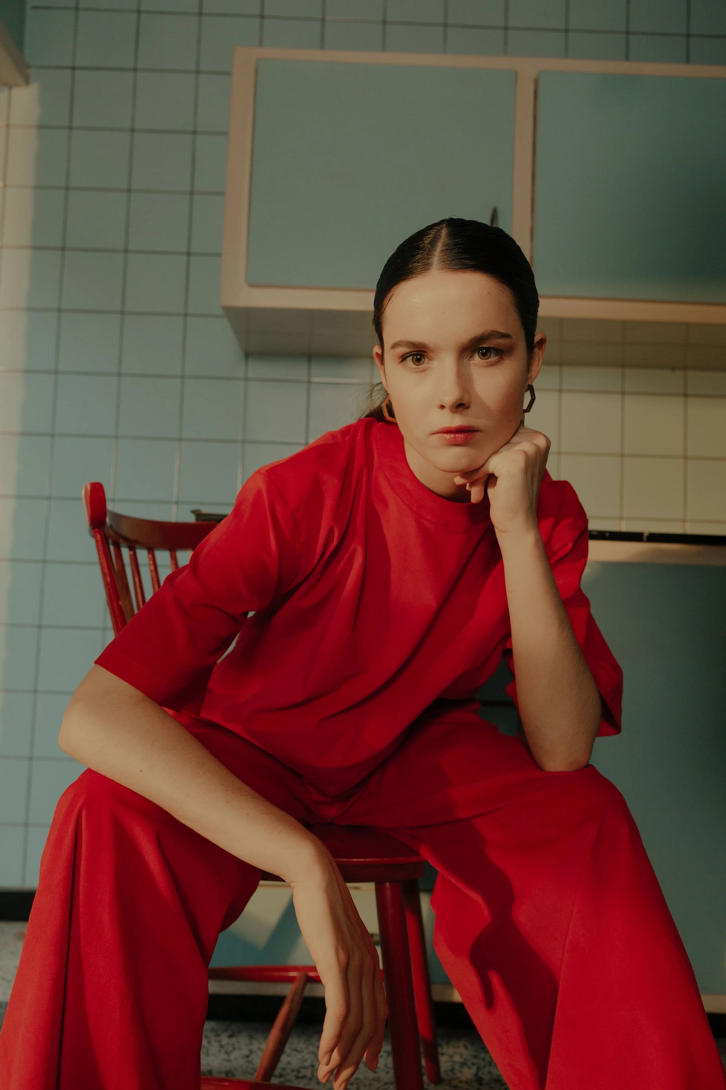 Model wearing the STEF SERIES Ciska T-shirt styled with the STEF SERIES wide-leg Caro Pants, both crafted from red velvet.