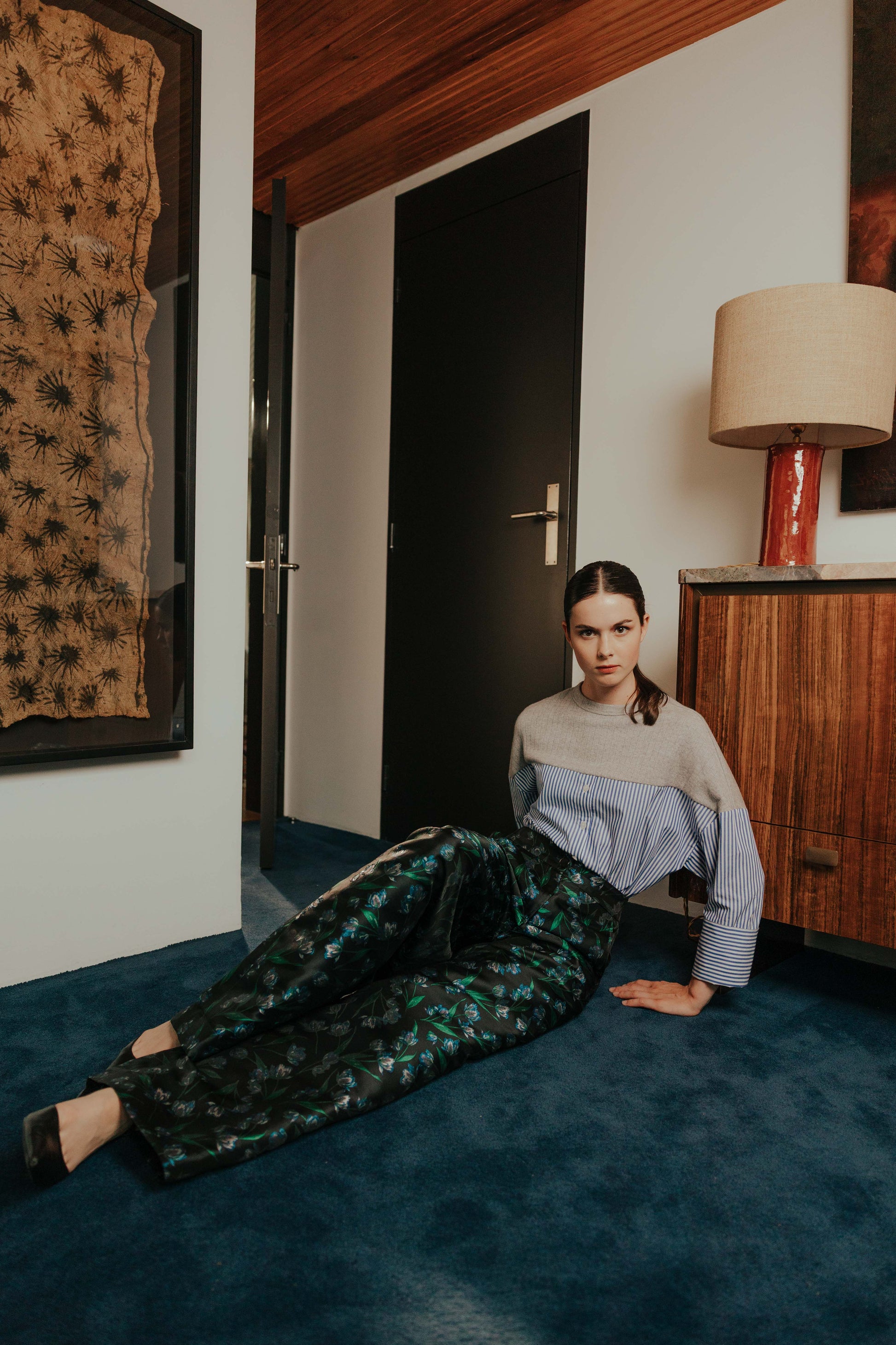 Model wearing the STEF SERIES Collin poplin shirt in blue stripes with the Caro wide-leg blue floral pants.
