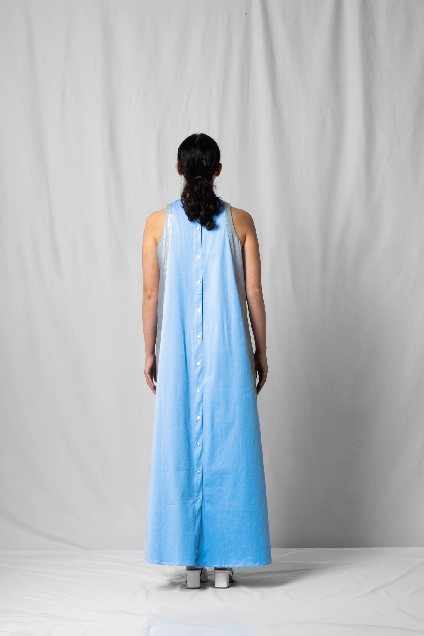 long, wide ciel blue halter dress with a two-fabric detail and button fastening at the back from the SS26 collection by STEF SERIES