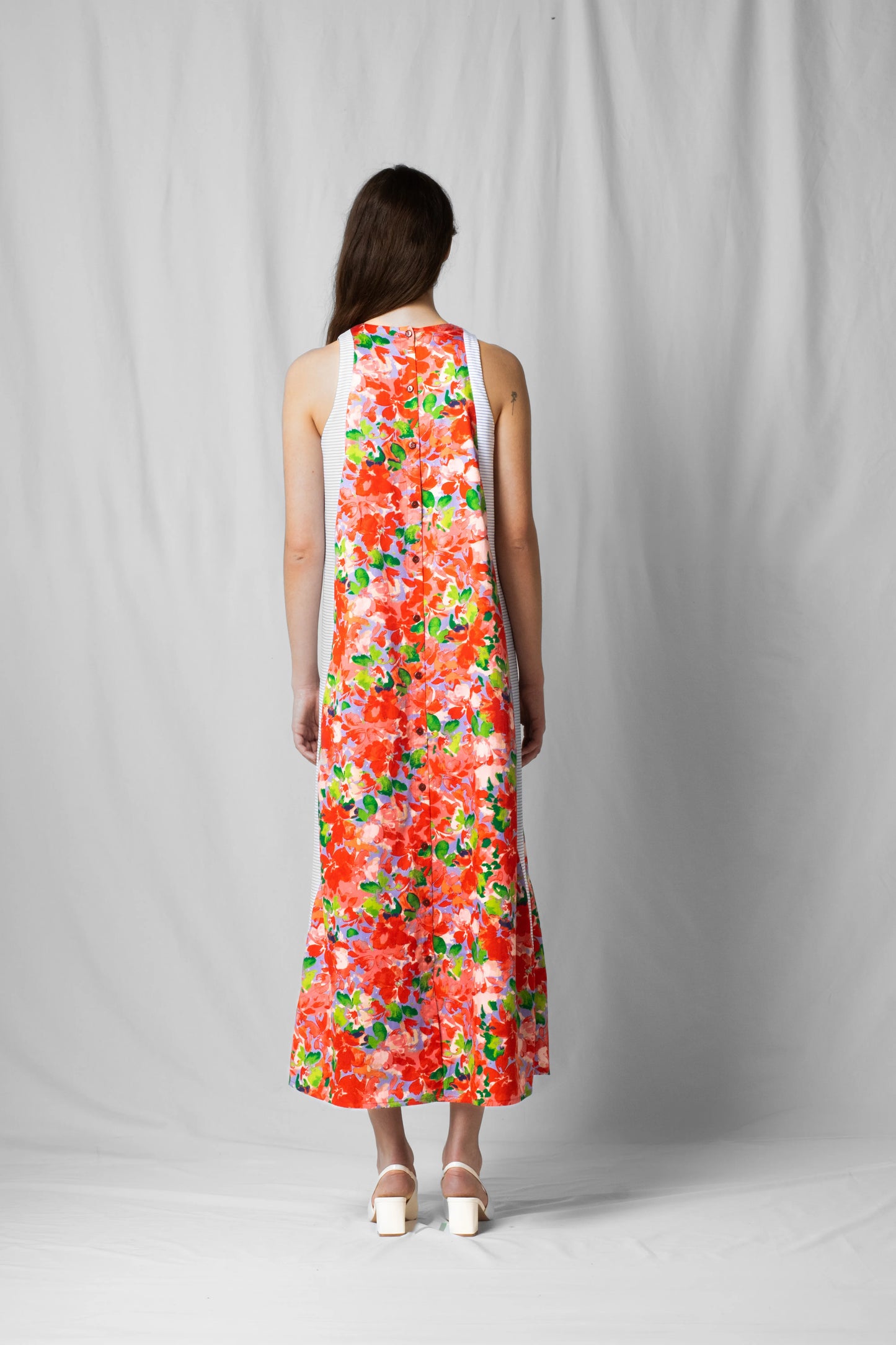 long, wide pink flowers halter dress with a two-fabric detail and button fastening at the back from the SS26 collection by STEF SERIES
