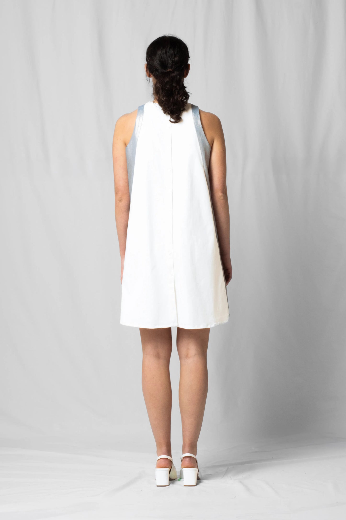 Short, wide ecru halter dress with a two-fabric detail and button fastening at the back from the SS26 collection by STEF SERIES
