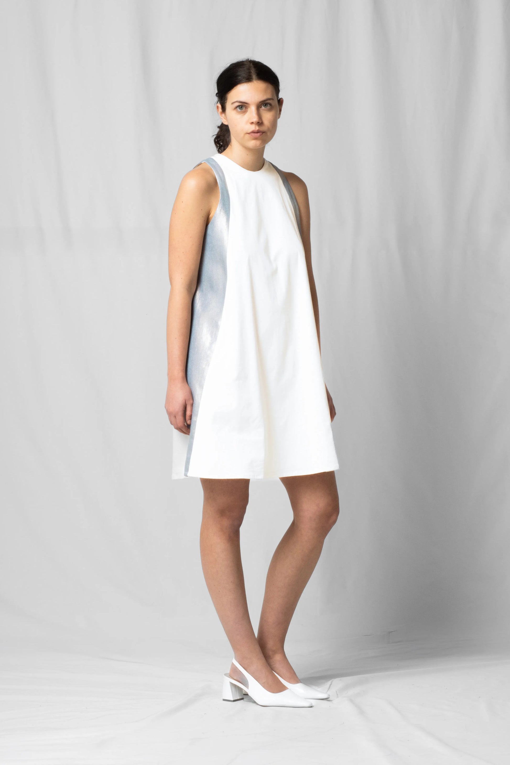 Short, wide ecru halter dress with a two-fabric detail and button fastening at the back from the SS26 collection by STEF SERIES