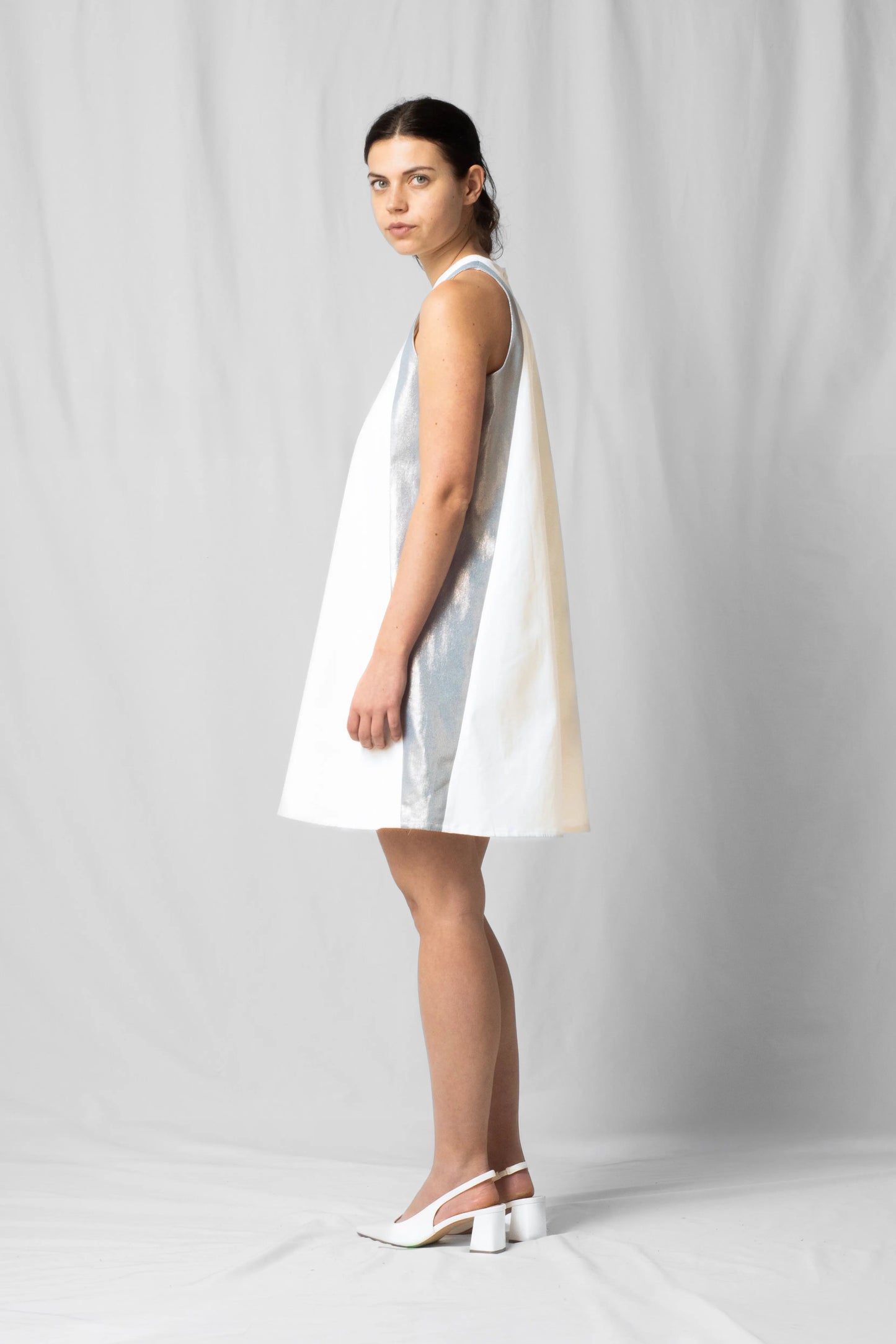 Short, wide ecru halter dress with a two-fabric detail and button fastening at the back from the SS26 collection by STEF SERIES