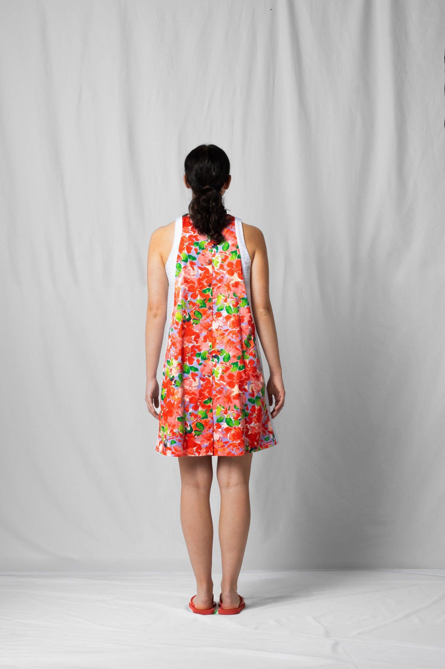 Short, wide pink flowers halter dress with a two-fabric detail and button fastening at the back from the SS26 collection by STEF SERIES