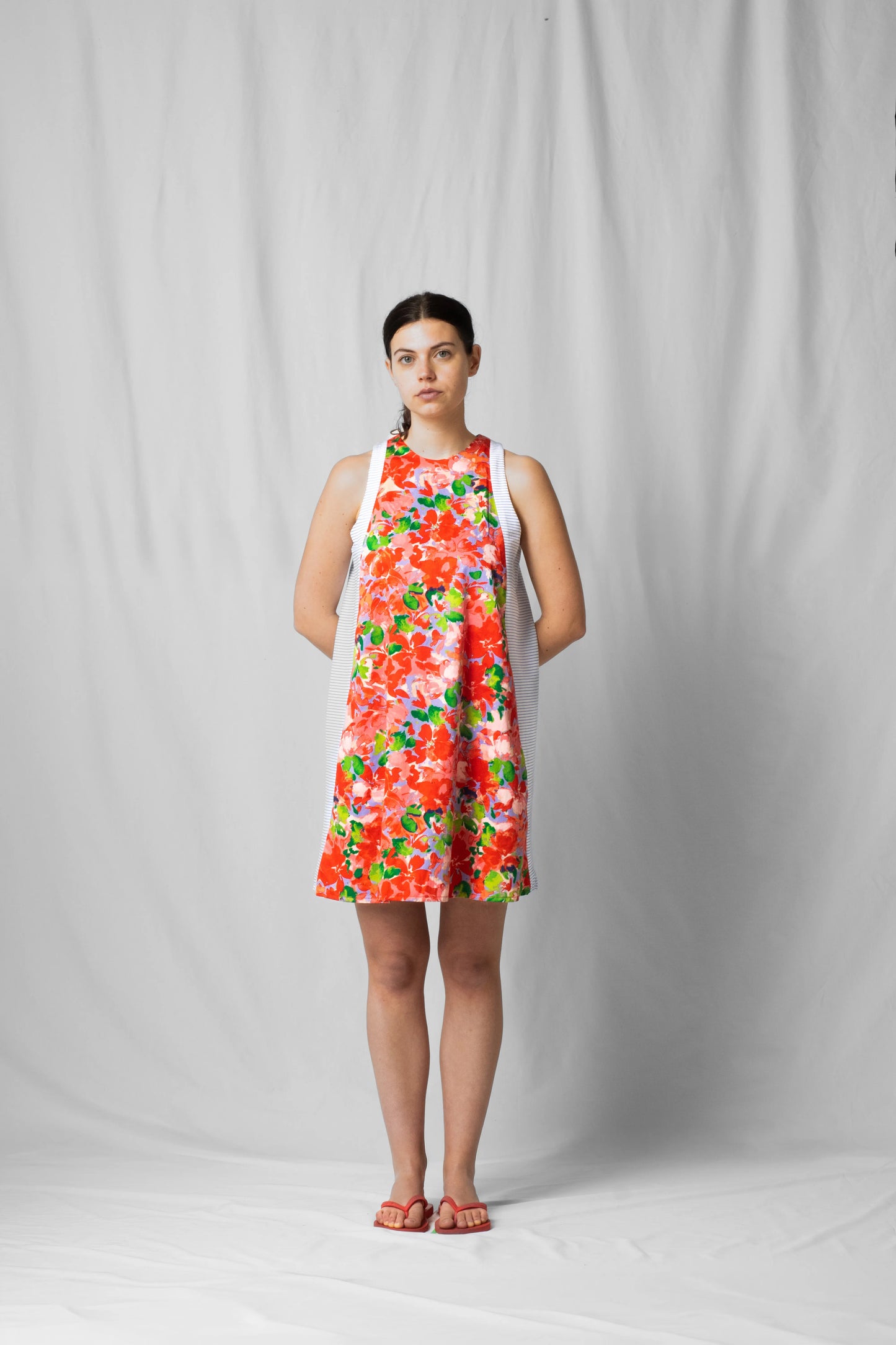 Short, wide pink flowers halter dress with a two-fabric detail and button fastening at the back from the SS26 collection by STEF SERIES