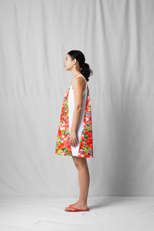 Short, wide pink flowers halter dress with a two-fabric detail and button fastening at the back from the SS26 collection by STEF SERIES