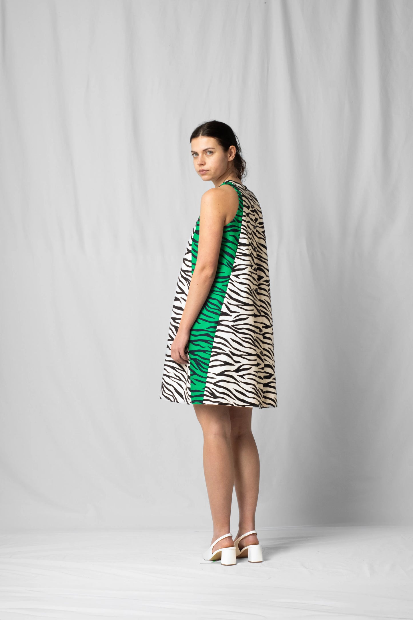 Short, wide white zebra halter dress with a two-fabric detail and button fastening at the back from the SS26 collection by STEF SERIES